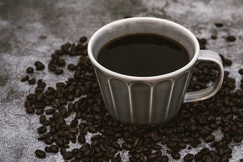 焙煎珈琲豆と注がれたブラックコーヒーの写真素材