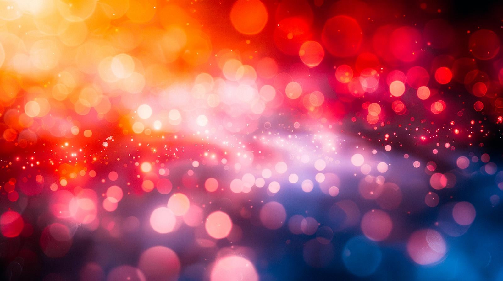 Abstract light effect with large and small bokeh orbs scattered on a background with a gradient transitioning from orange to red to blue