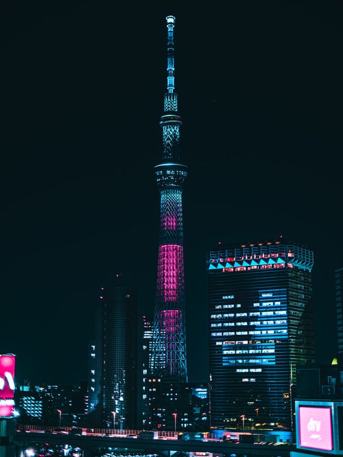 ライトアップされたハートのビルと東京スカイツリーの写真