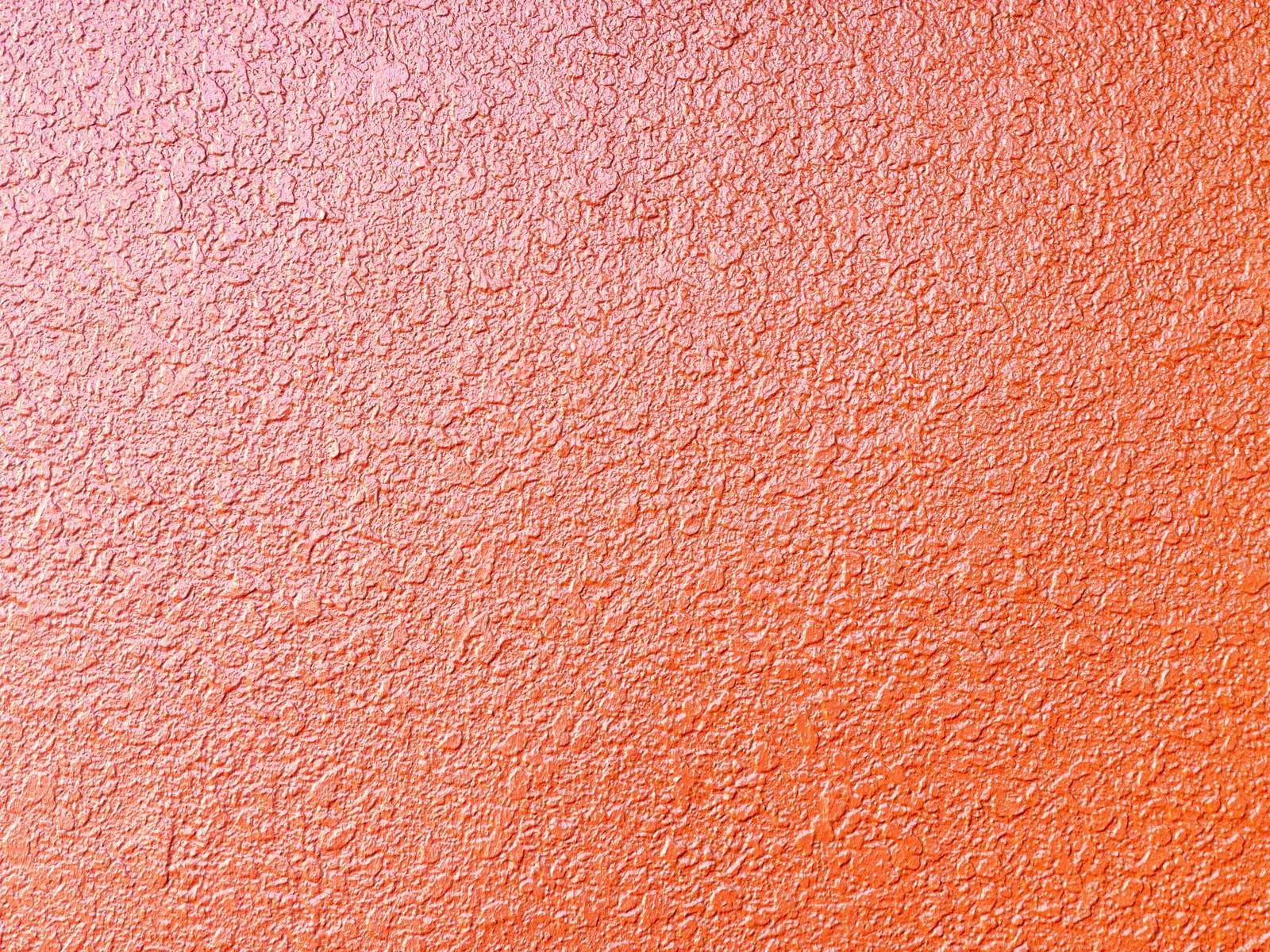 「オレンジ色のモルタル壁のテクスチャー」の写真