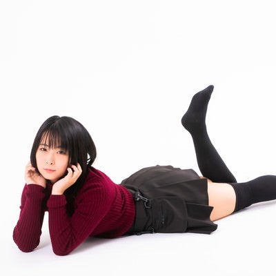 頬杖をついて横たわる女性の写真