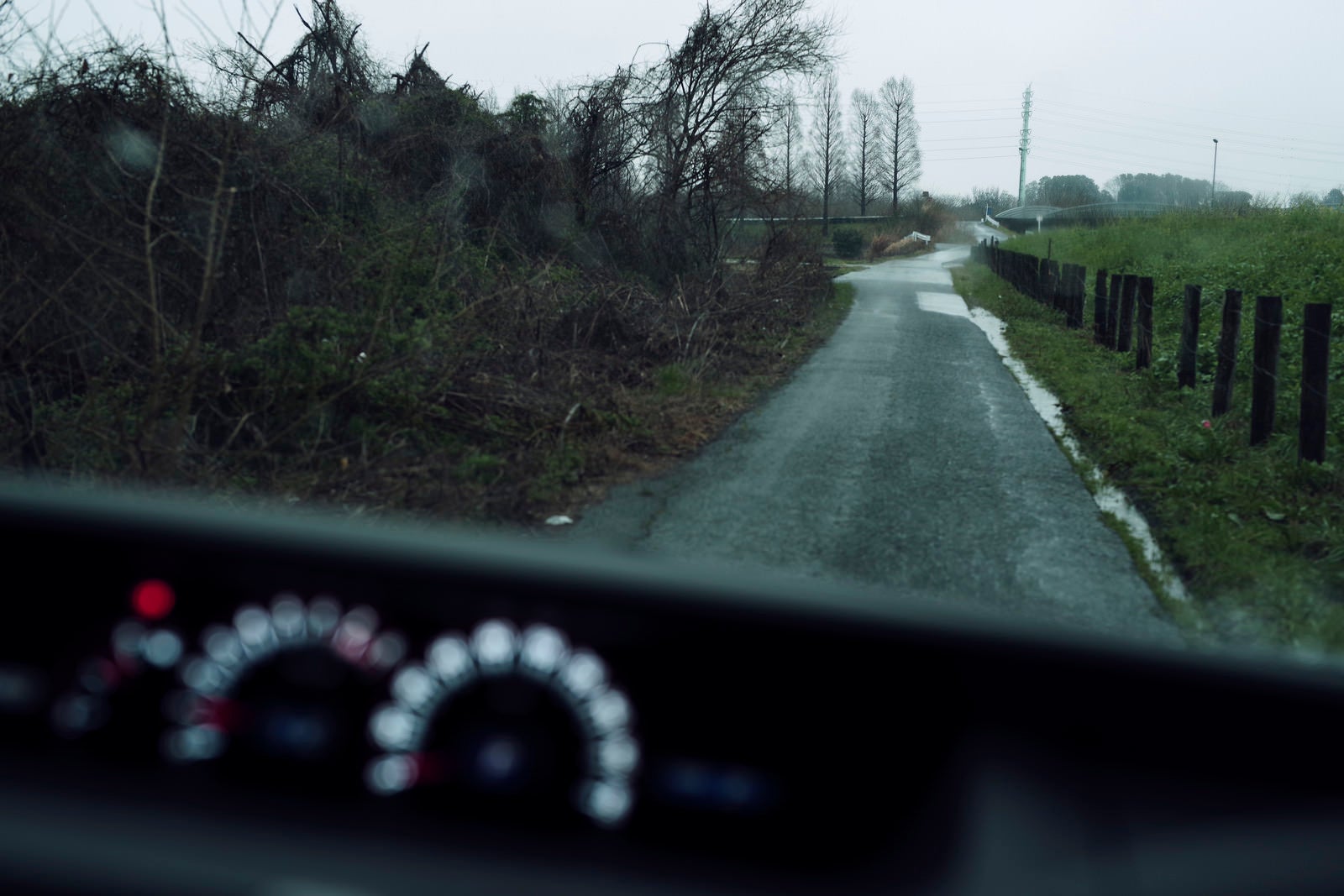 「雨の中の農道を走る車から見た景色」の写真