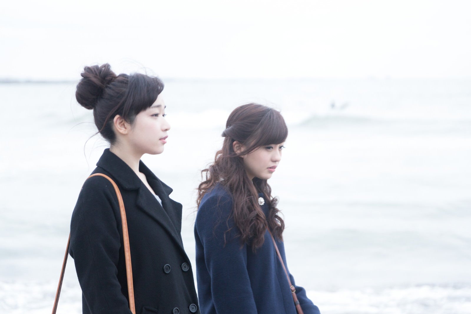 「女性二人で冬の海を歩く」の写真［モデル：河村友歌 渡辺友美子］