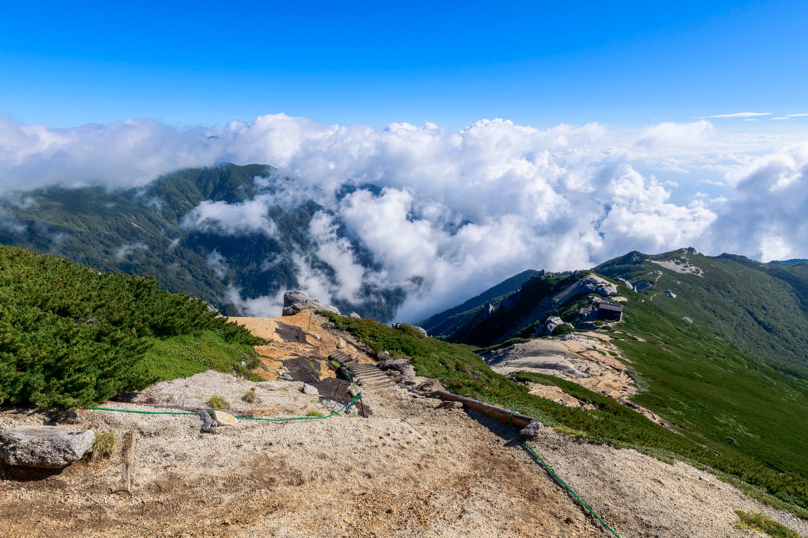 「雲に包まれる中央アルプスと駒峰ヒュッテ」の写真