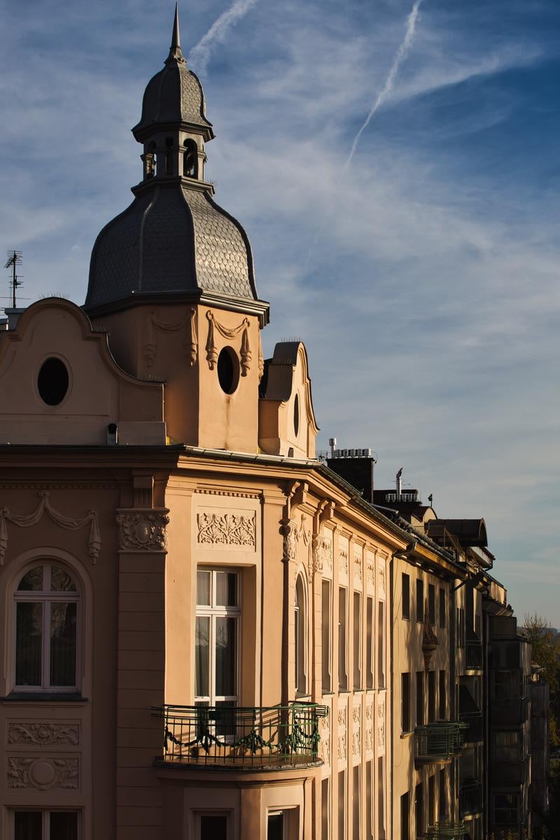 ドーム型の黒い尖塔が特徴的なクラクフの歴史的建造物の外観