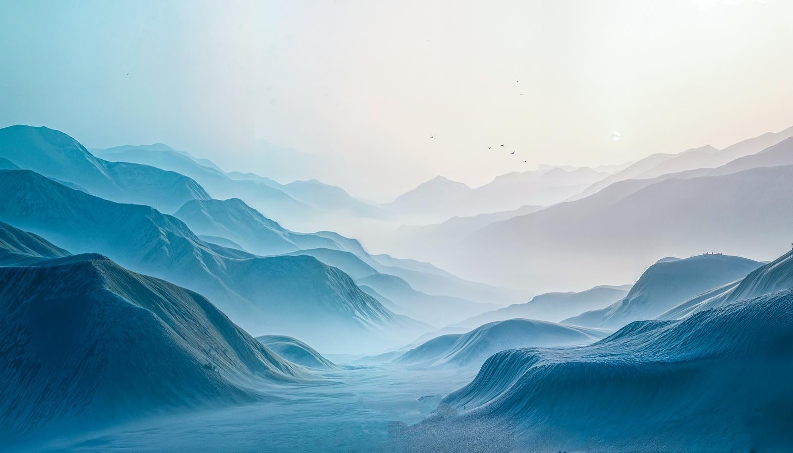 A landscape where bluish mountain ranges overlap in multiple layers within dense fog, gradually fading into haze toward the distance