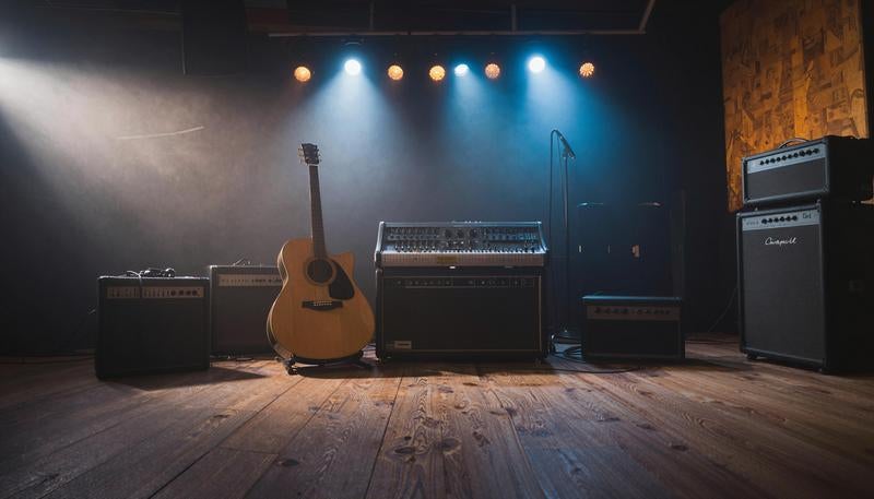 Acoustic Guitar and Audio Equipment Arranged in Studio