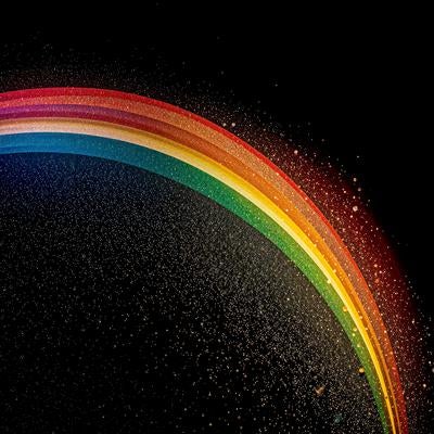 黒背景に輝く虹色アーチとキラキラ粒子のデジタルアートの写真