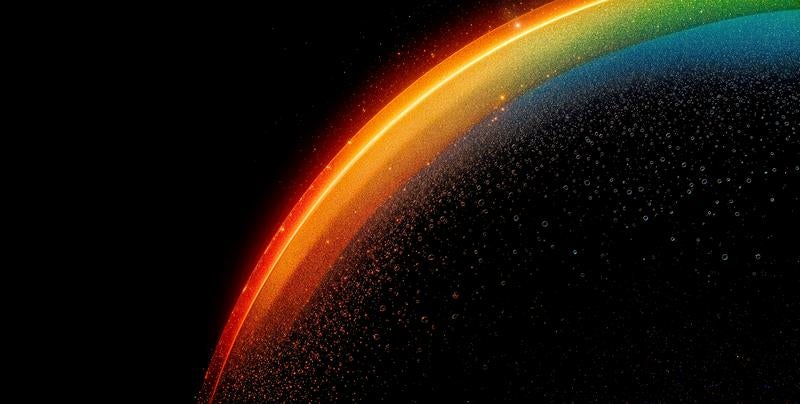 暗闇に輝く七色の光の帯の写真