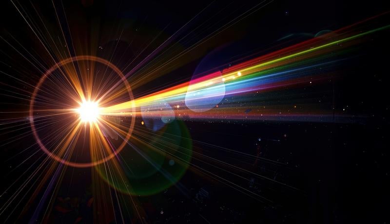 暗闇に広がる虹色の光芒