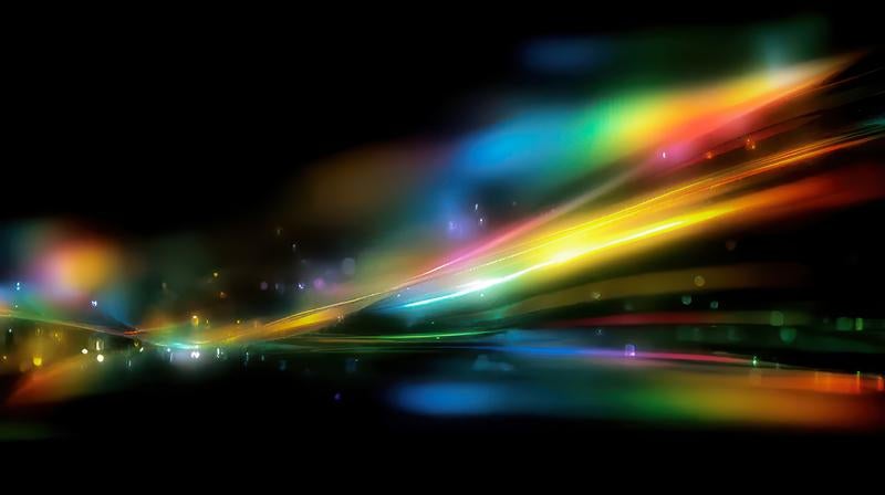 虹色の光が暗闇に滑らかに広がる様子の写真