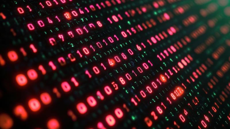 赤と緑のバイナリコードが発光するサイバー空間の写真