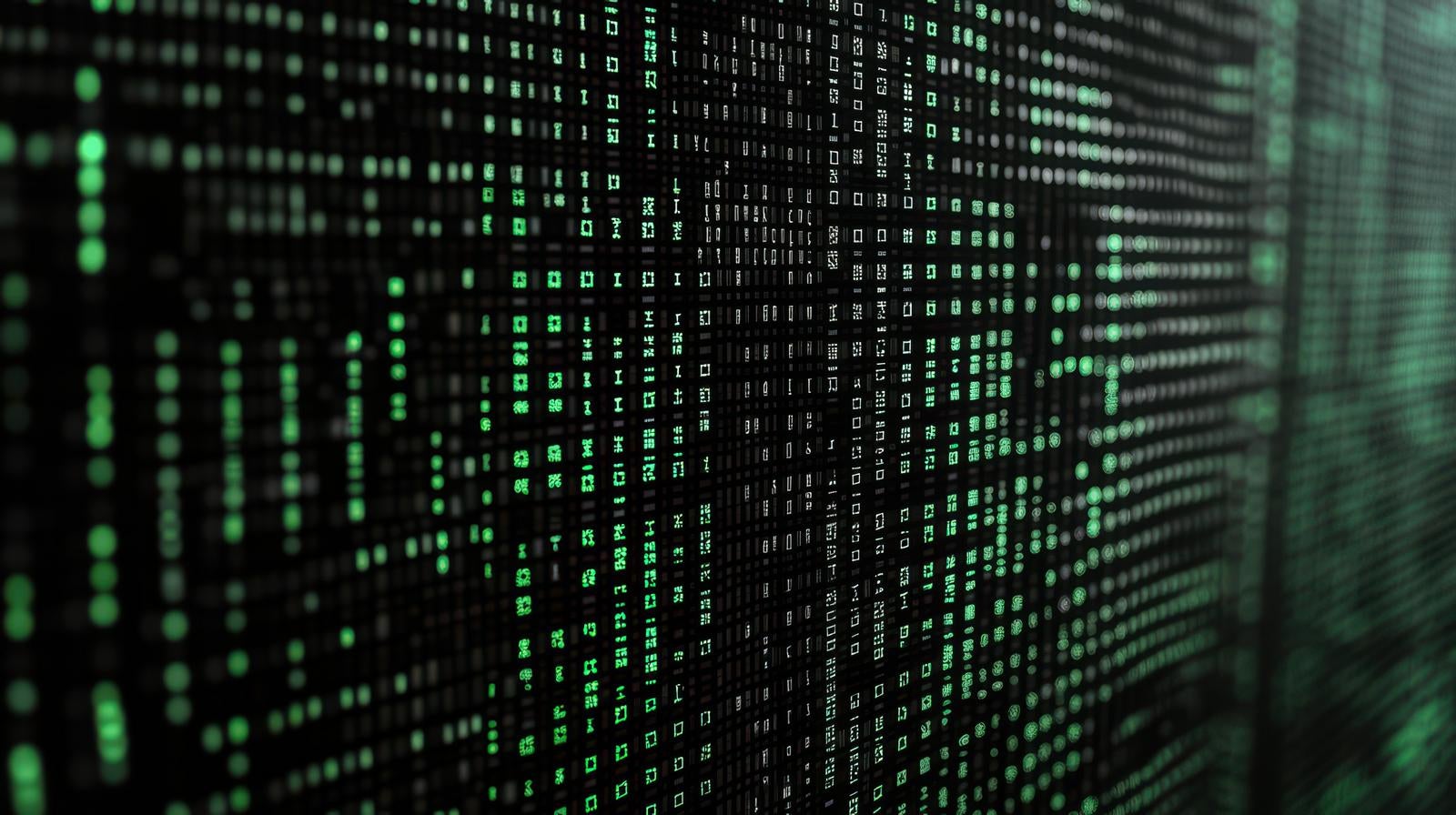 「緑色の暗号化データが流れるデジタル画面」の写真