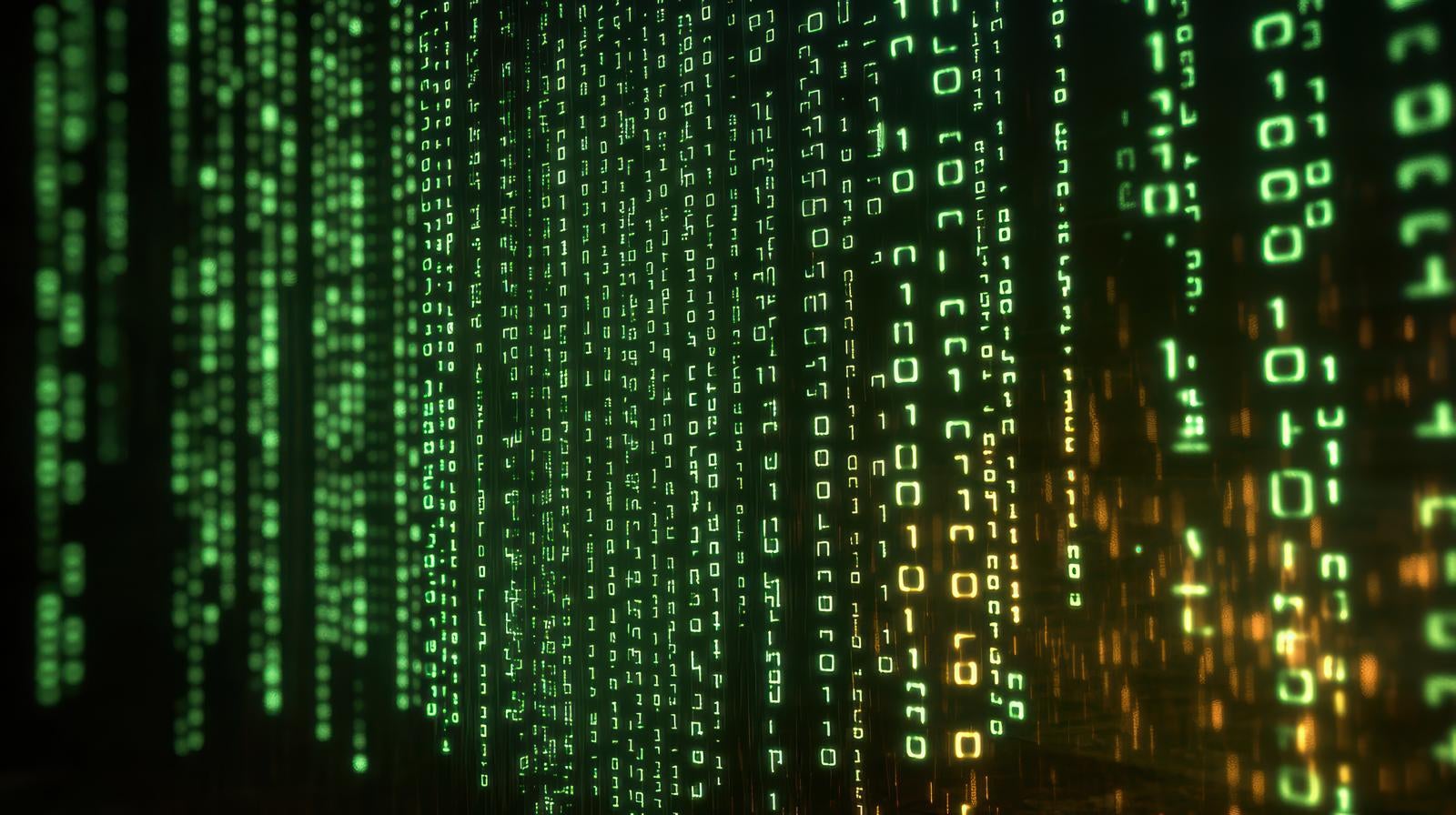 緑とオレンジのバイナリコードが縦に流れる暗い画面