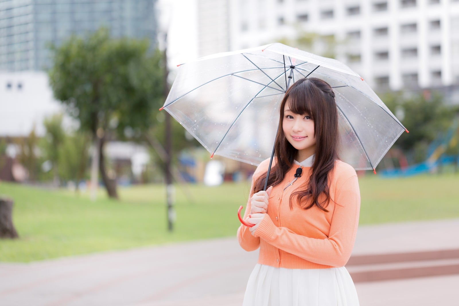 「雨の中、今日の天気を伝えるお姉さん」の写真［モデル：茜さや］