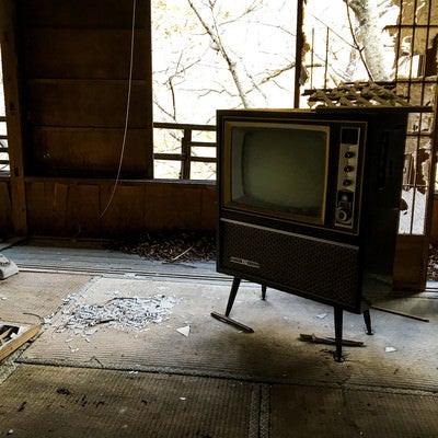 廃屋に残された古いアナログテレビの写真
