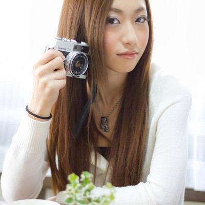 レトロなカメラを持つ女性の写真