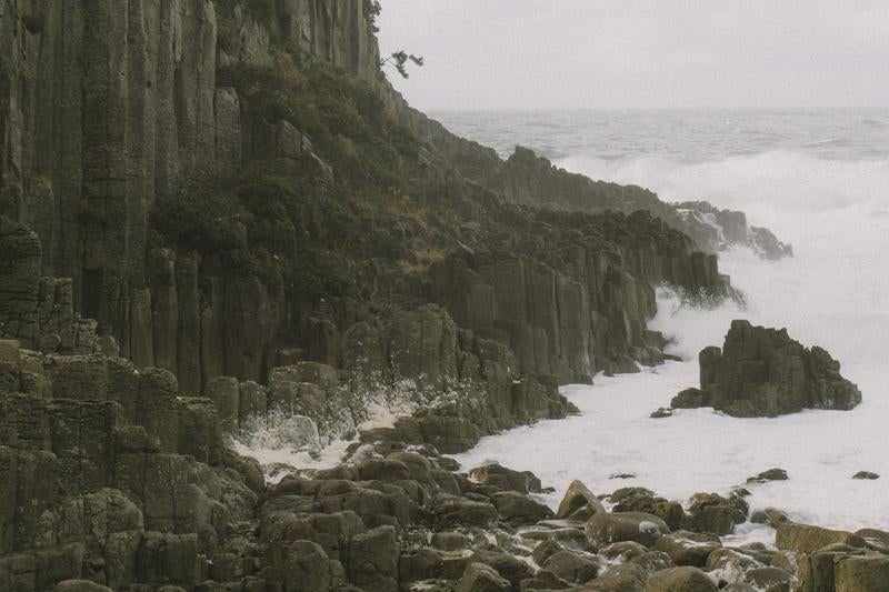 鉾島の岩場に集まる荒波の写真