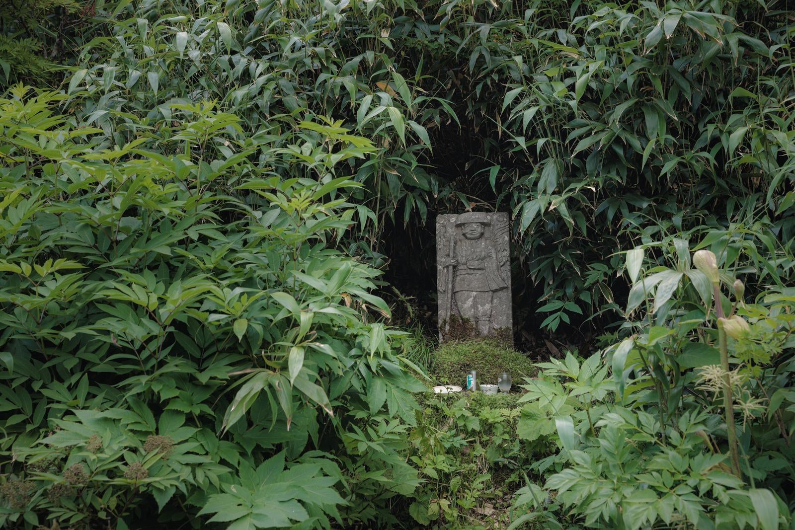 「猪苗代登山口の石碑、磐梯山の木々に守られた歴史」の写真