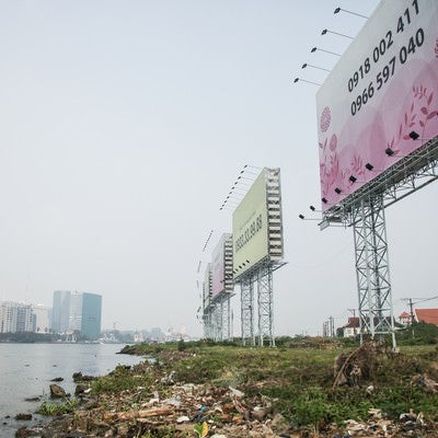 ホーチミンの沿岸のゴミと広告看板の写真