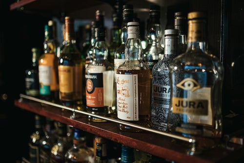 バー店内の酒棚に並んだウイスキーの写真