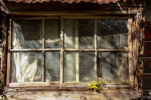 木造の廃屋の窓の写真