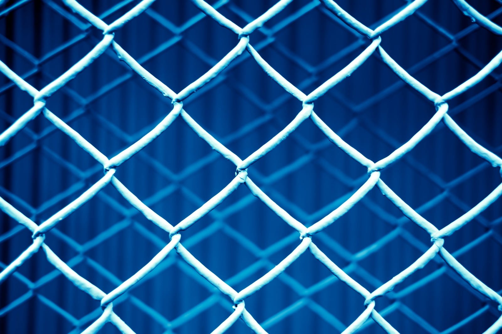 「重なった金網フェンス（青）」の写真