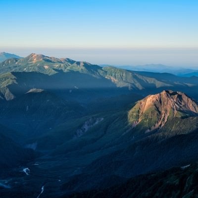 朝焼けに照らされる焼岳と乗鞍岳の写真