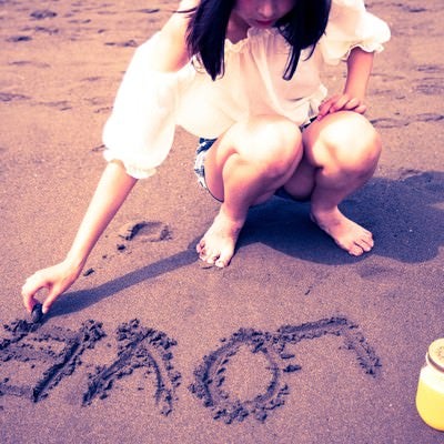 砂浜に「LOVE」を書く女の子の写真