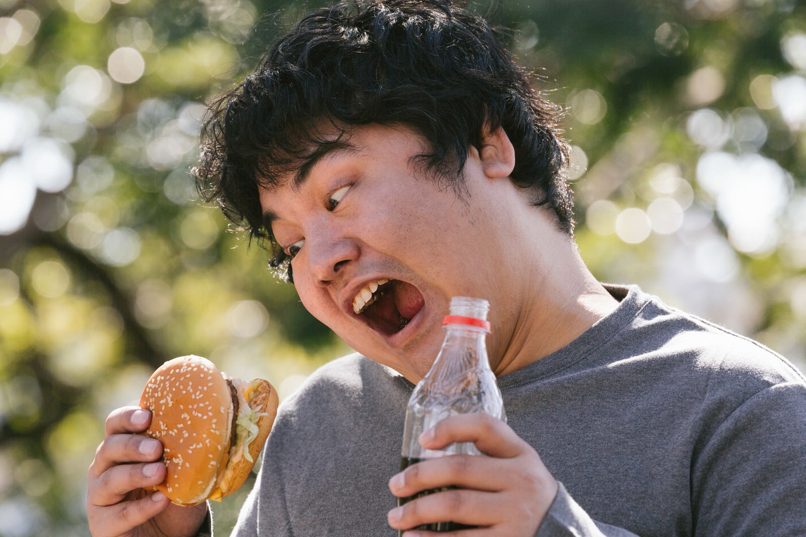 「ハンバーガーとコーラのスペシャルセットに大歓喜」の写真［モデル：段田隼人］