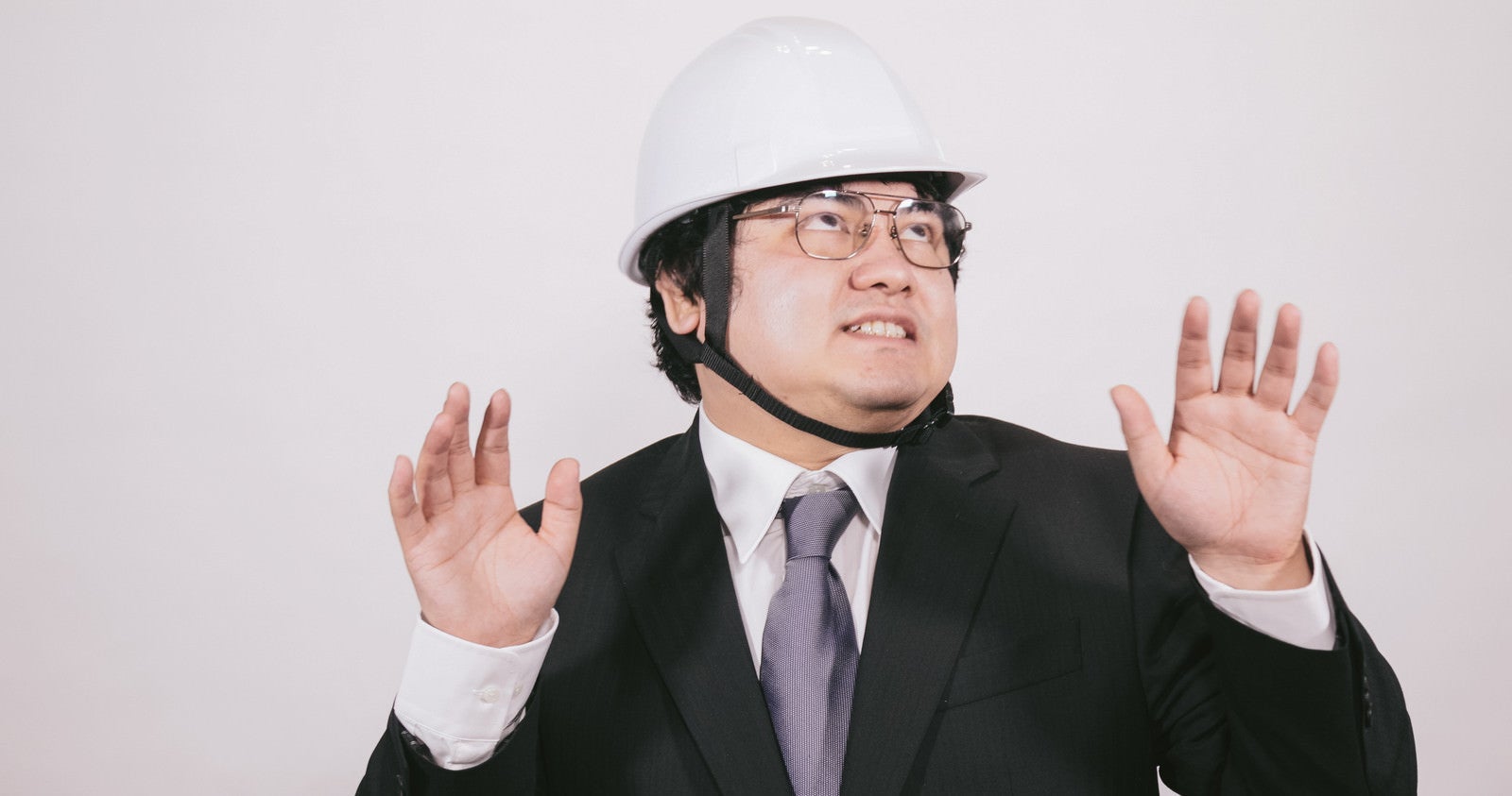 「ヘルメットを着用して安全に備えるビジネスマン」の写真［モデル：段田隼人］