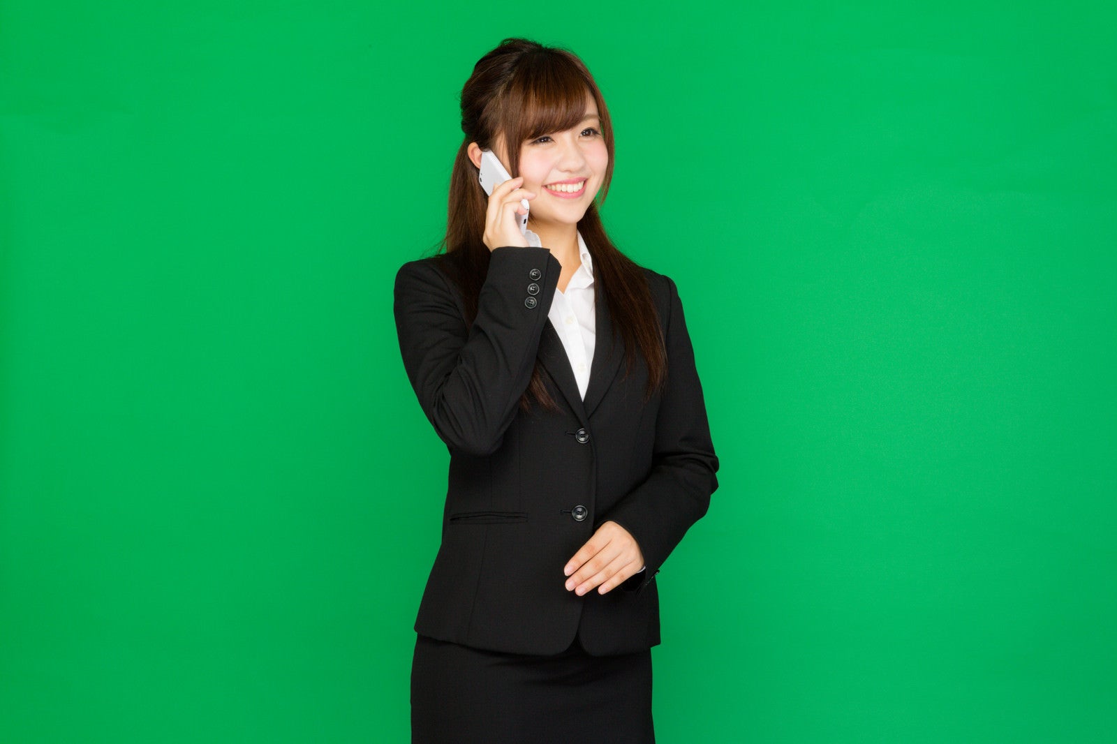「笑顔で電話対応する女性」の写真［モデル：河村友歌］