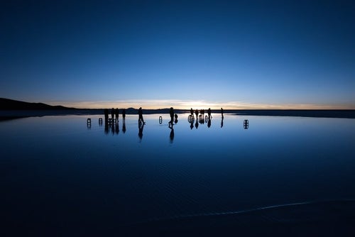 ウユニ塩湖の日の出を待つ人の写真