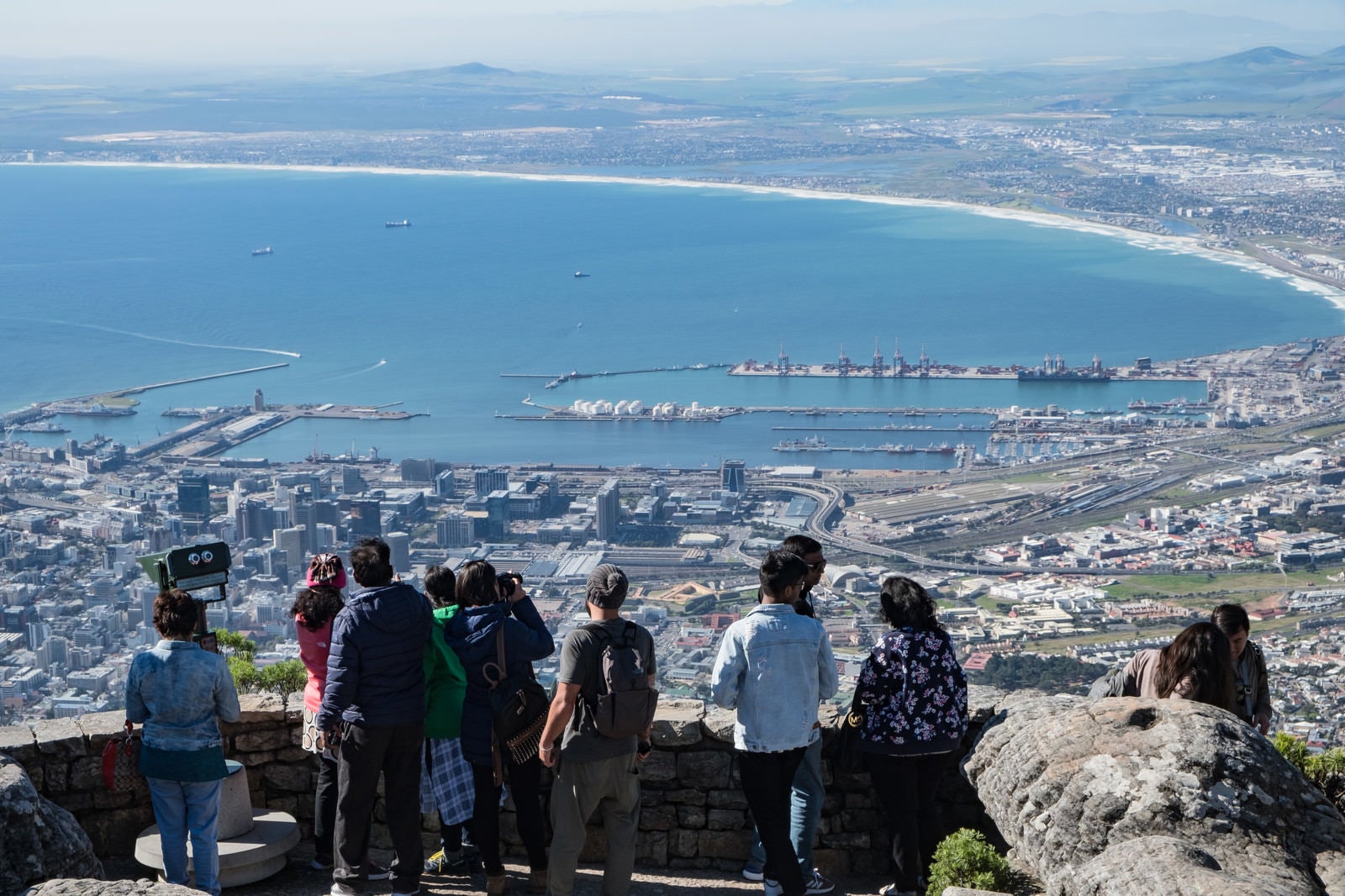 「テーブルマウンテン頂上から見たケープタウン市内の街並みと観光客（南アフリカ）」の写真