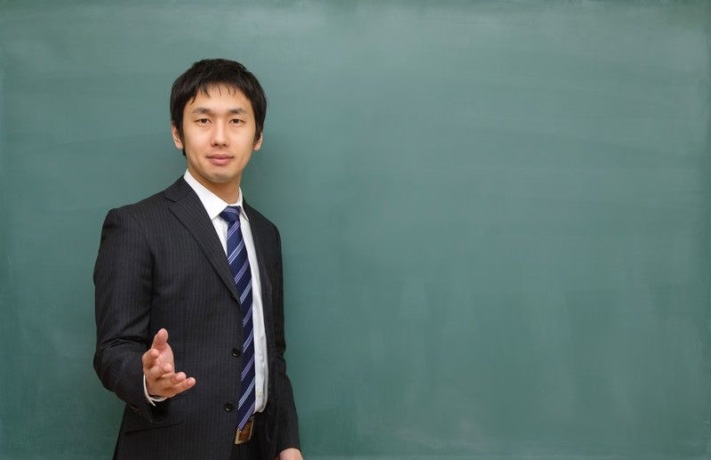 優しい顔で授業を行う塾の講師の写真