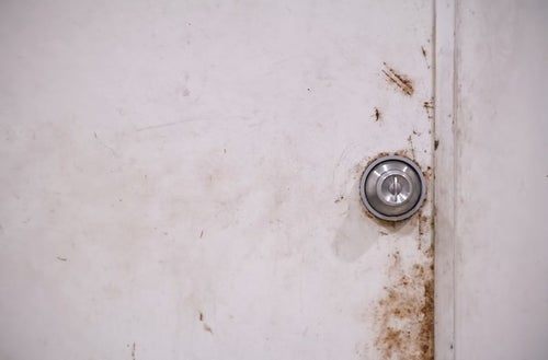 錆びた扉と鉄のドアノブの写真