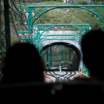 男山ケーブルの乗客越しに見るトンネルの写真