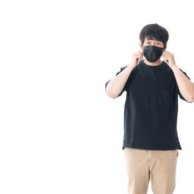 黒いマスクで顔を覆う男性の写真