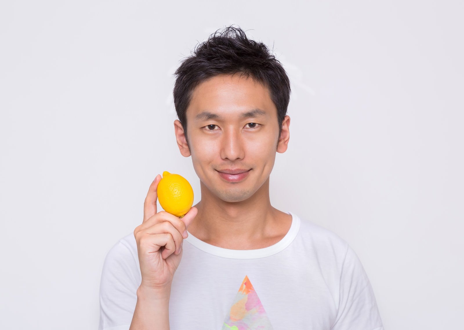 「雑誌の表紙でレモンを持つ男性」の写真［モデル：大川竜弥］