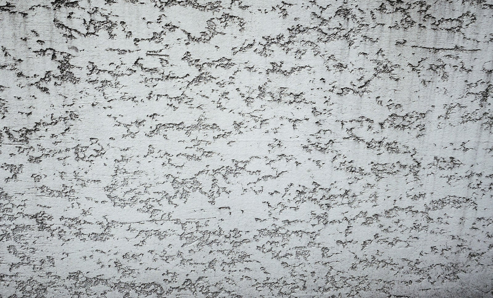 「まばらに隙間の空いたコンクリート壁（テクスチャー）」の写真
