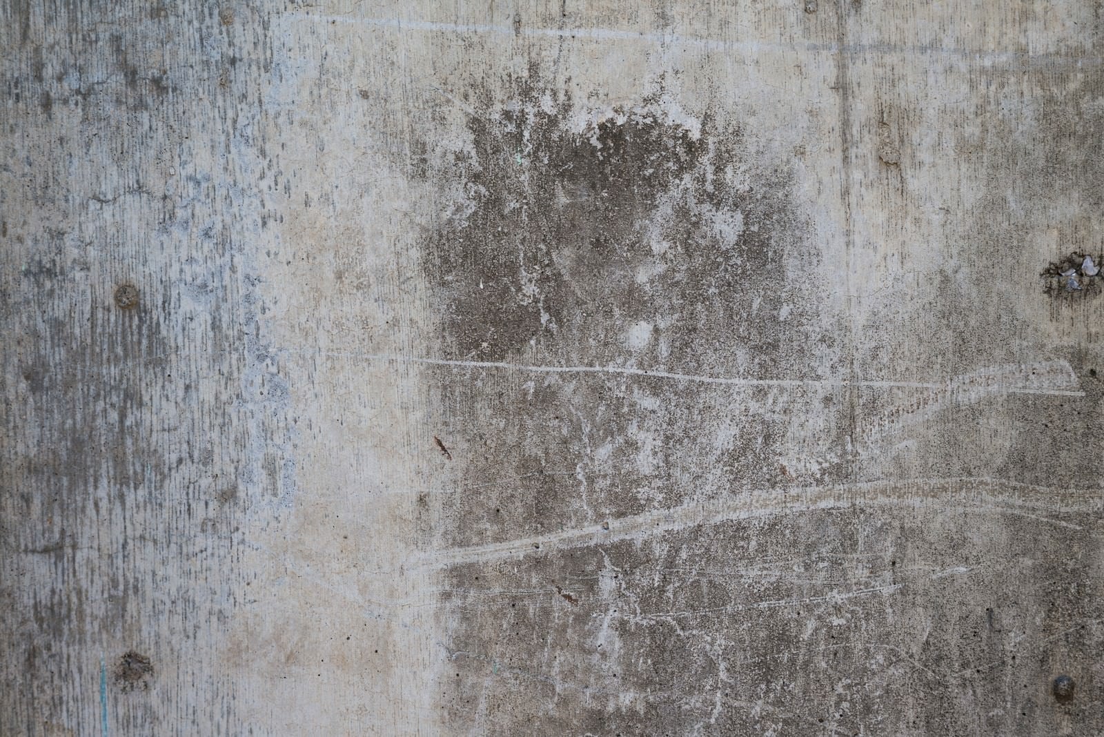 「汚れとシミがついたコンクリートの壁」の写真