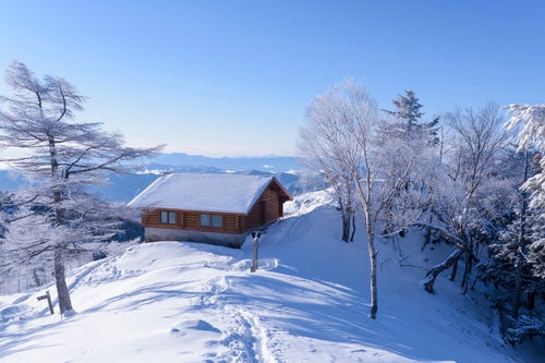 雪に包まれた雲取山山頂と雲取山避難小屋の写真