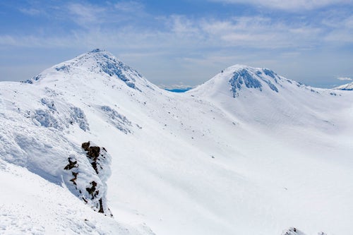 雪に包まれた乗鞍岳の山頂の写真