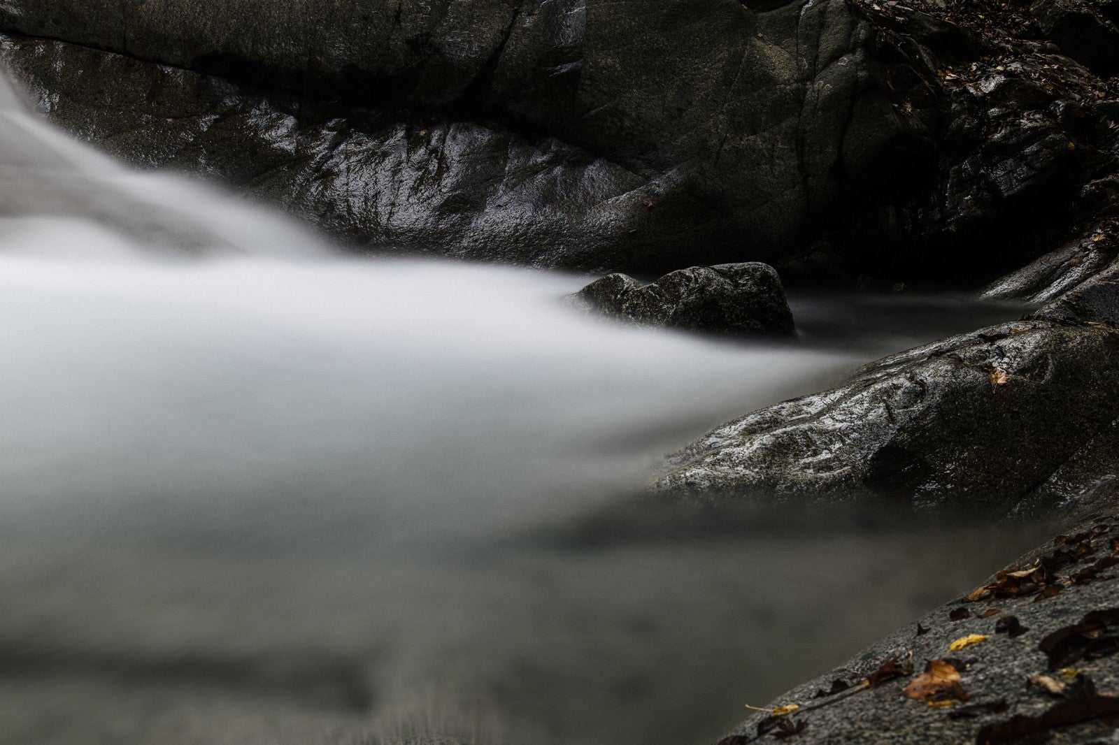 「黒い岩と白い渓流」の写真