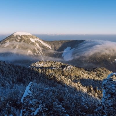 滝雲が通り過ぎる冬の蓼科山の写真