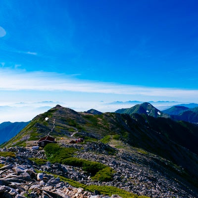 大天井岳山頂から見る大天井岳の山荘（常念岳）の写真