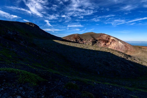 夕日に浮かび上がる妙高岳（岩手山）の写真