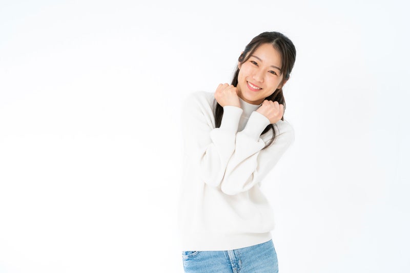 笑顔でぶりっ子ポーズの女性の写真