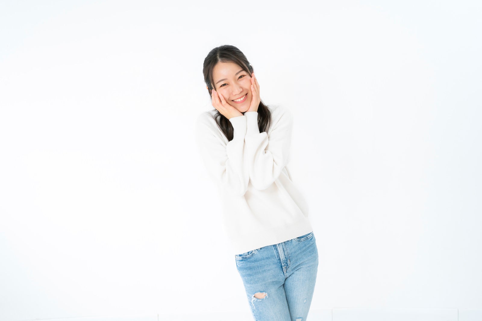 Woman smiling with her hands on her cheeks