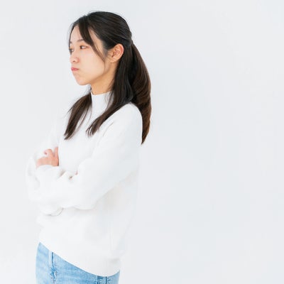 腕組みしてそっぽを向く女性の写真